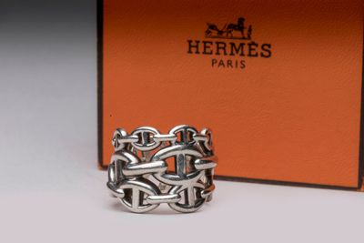 a close up of a silver ring with a box in the background