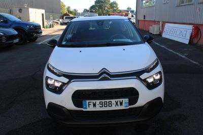 the front of a white citrole parked in a parking lot