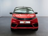 the front of a red toyota yaris parked in a showroom