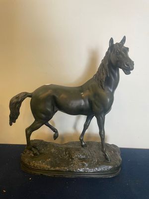 statue of a horse running on a black surface