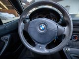 a steering wheel and dashboard of a car in a parking lot