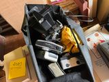 a bag full of cameras and other items on a table