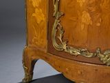 a wooden cabinet that has a gold decoration on it