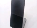 a black cell phone sitting on top of a stand