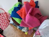 a pile of clothes on a table next to a mirror