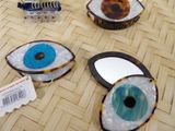 three different types of eye shaped mirrors on a table