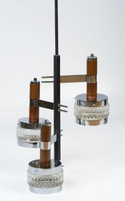 two lights that are hanging from a metal pole