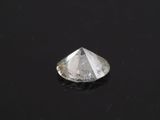 a close up of a white diamond on a black surface