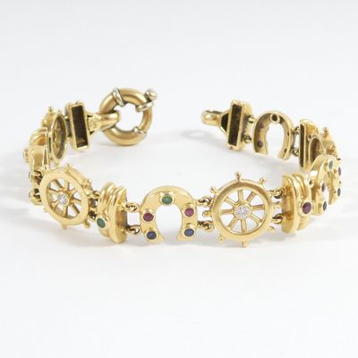 an image of a gold bracelet with multi colored stones on it