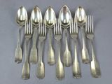 six spoons and six forks are arranged in a row on a table