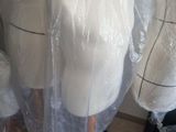 several mannequins wrapped in plastic sitting on top of a table