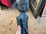 a person holding a statue of a monkey in their hand