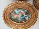 a gold frame with a picture of a woman on it