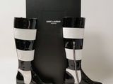 the pair of black and white boots are next to a black box