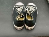 a pair of black and white shoes on a table