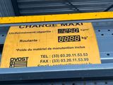 a yellow sign on the side of a metal shelf