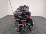 a black motorcycle parked in a room with a checkered floor