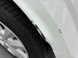 a close up of a car ' s front bumper and tire