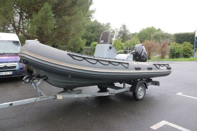a small boat on a trailer in a parking lot