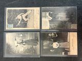 four old baseball cards are sitting on a black table