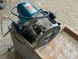 a machine that is sitting on the ground in front of a box