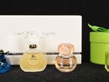 three bottles of perfume sitting next to each other on a table