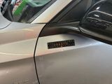 a car with a sticker on the side of it ' s door
