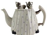 a white tea pot with blue flowers on it