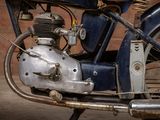 a close up of a motorcycle with a small engine on it