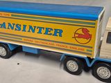 a toy truck that is sitting on a white surface