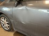 a car that has been dented and is in a garage