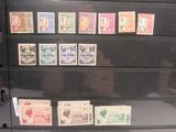 many different types of stamps on a black filing cabinet