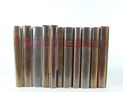 six books are lined up in a row on a white surface