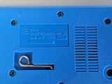 a blue electronic device sitting on a white surface