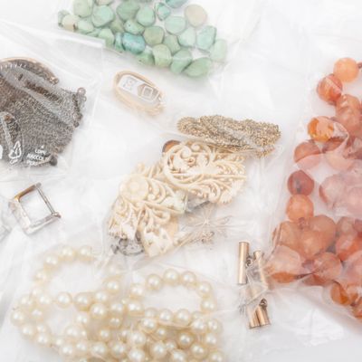 many different types of jewelry on a white surface