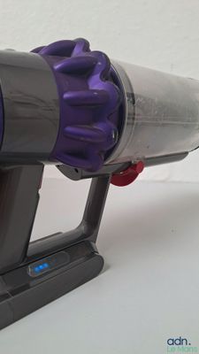 a purple and gray vacuum that is sitting on a table