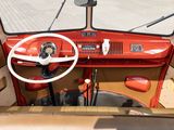a red car with a steering wheel and a steering wheel