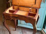 a small wooden table with a drawer on it