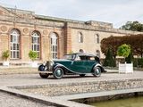 a vintage car that is parked in front of a building