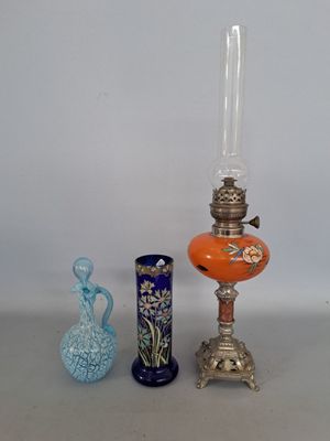 three different vases and a lamp on a table