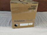 a box that is sitting on a bed with a white sheet