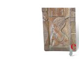 relief of a woman in a headdress on a plaque