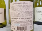 three bottles of wine sitting on top of a table next to each other