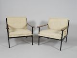 a pair of mid century modern lounge chairs