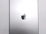 an apple ipad sitting on top of a white table next to a white wall
