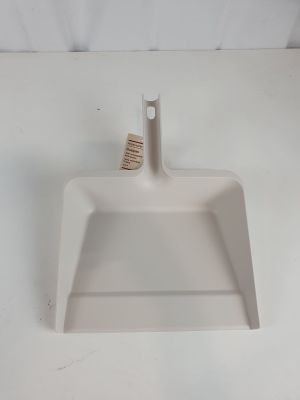 a white dust pan on a white counter top