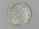 a close up of a coin on a white surface