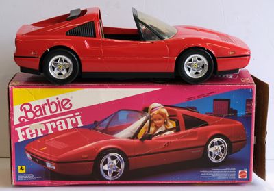 a red toy car sitting on top of a box