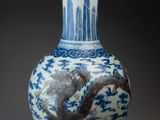 an image of a blue and white vase with a bird on it