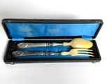 two forks and a spoon in a black case